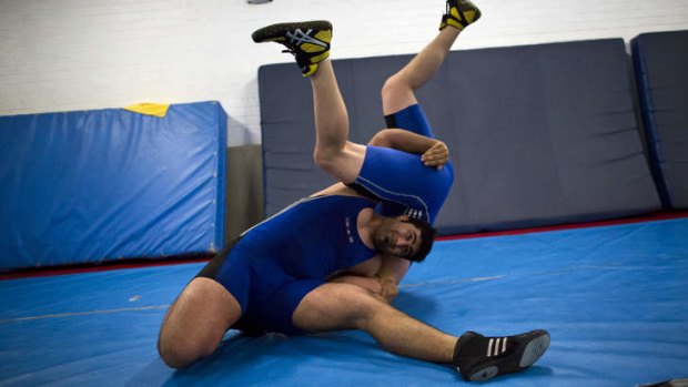 Champion: (Clockwise from top left) Arzhang Janipour grappling an opponent during training.