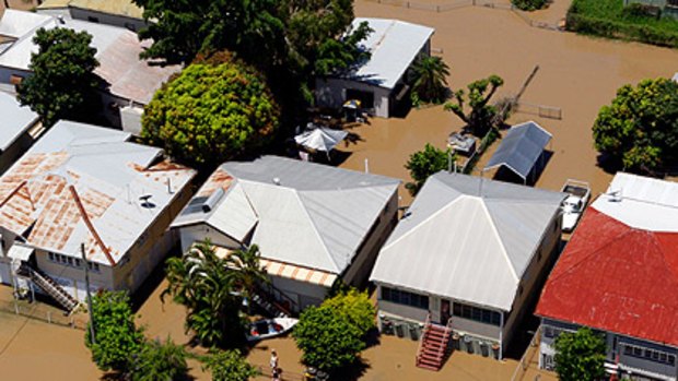 Flooded houses in Rockhampton, photographed yesterday. The waters are expected to peak today.