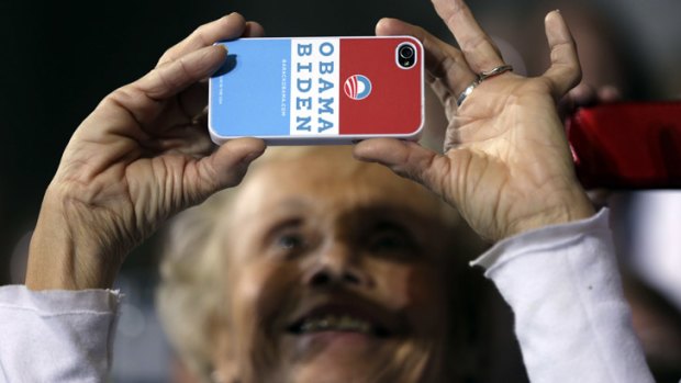 A woman captures the moment with her mobile phone as Vice-President Joe Biden speaks at a campaign rally in Lancaster, Ohio.