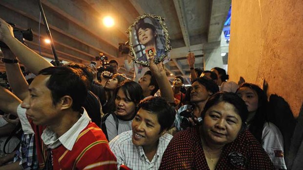 Supporters of Myanmar opposition leader Aung San Suu Kyi cheer upon her arrival at Bangkok's Suvarnabhumi Airport.
