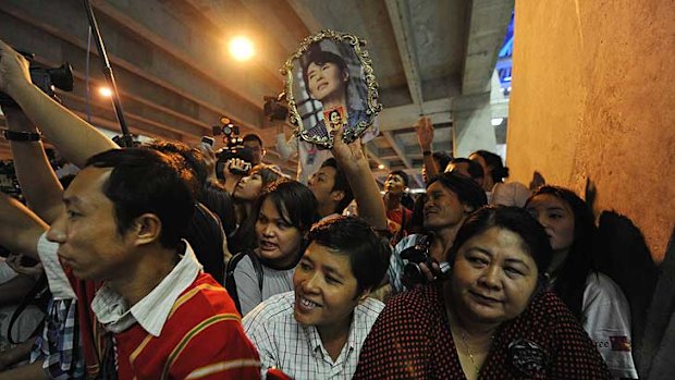 Supporters of Myanmar opposition leader Aung San Suu Kyi cheer upon her arrival at Bangkok's Suvarnabhumi Airport.