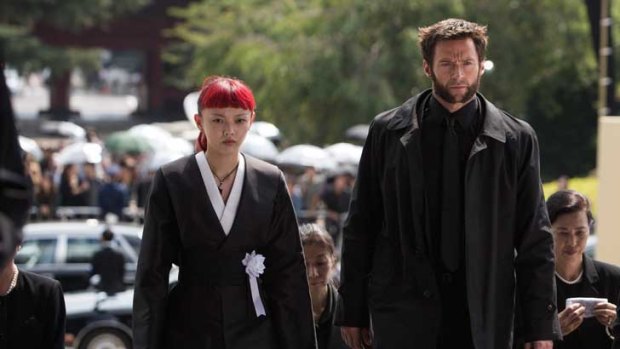 A funeral begins: Rila Fukushima and Hugh Jackman in <i>The Wolverine</i>.