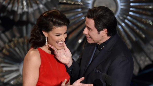 Idina Menzel, left, and John Travolta present the award for best original song at the Oscars at the Dolby Theatre in Los Angeles.