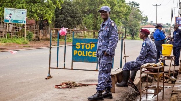 Police guard a roadblock during the three-day lock down on movement, an attempt to fight the Ebola virus, in Freetown, Sierra Leone.