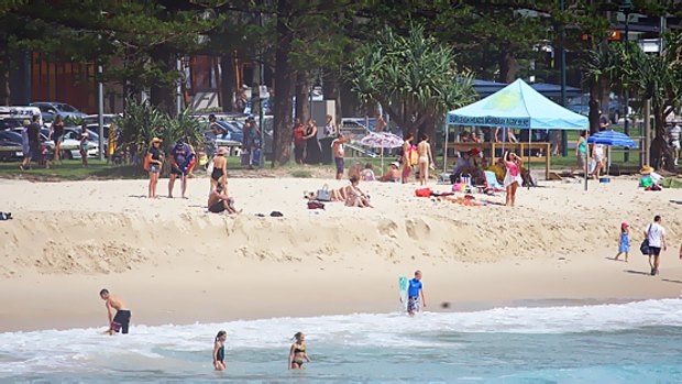Gold Coast beaches were almost as busy as usual on Sunday morning despite pleas from authorities to stay away.