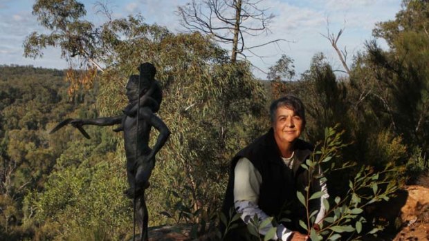 Set in stone &#8230; Aunty Patricia Madden, Gomeroi elder and cultural guide, beside a sculpture in the scrub at Dandry Gorge.