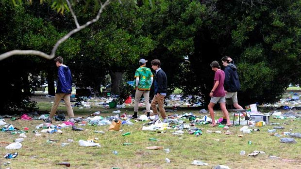 Partygoers wade through the mess at Edinburgh Gardens.