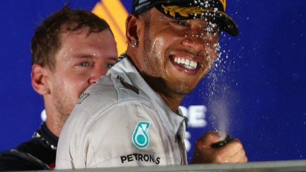 Winner: Lewis Hamilton is soaked with champagne by Sebastian Vettel.