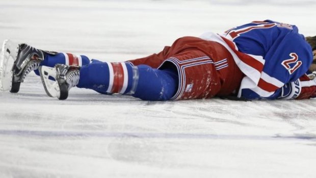 New York Rangers center Derek Stepan (21) lies on the ice after taking a hit from Montreal Canadiens forward Brandon Prust.