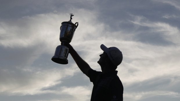 Cup runneth over: Justin Rose holds the US Open trophy aloft.