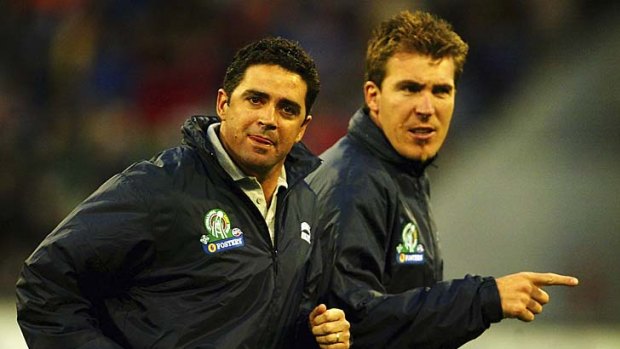 Garry Lyon, coach of the Australian team, and Jim Stynes leave the ground during the second match of the International Rules series between Australia and Ireland at the MCG in 2003.