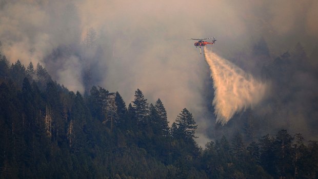 A Helitanker 743 drops on a wildfire on Mount St Helena, above Knights Valley north of Calistoga, California on Friday.