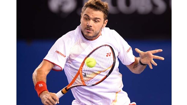 Switzerland's Stanislas Wawrinka advances to play a backhand during his fourth-round match against Spain's Tommy Robredo on Sunday.