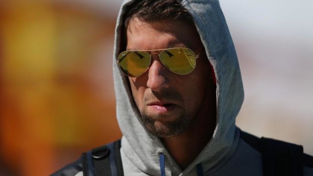 Back in the sun: Michael Phelps leaves team training.
