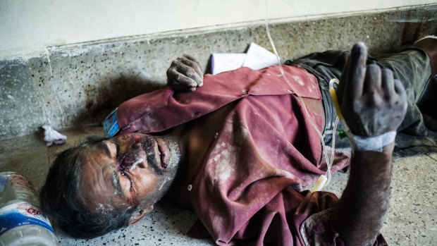 A Bangladeshi survivor of the collapse of a partly-built cement factory in southern Mongla town, lies on the floor of a hospital in Khulna.