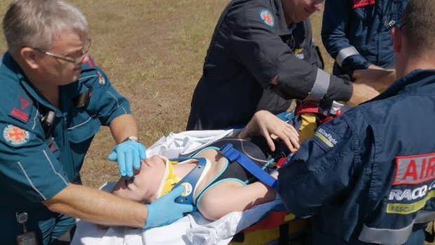 RACQ Rescue Flight workers and Ambulance workers tend to Stephanie Campbell after her skydiving accident.