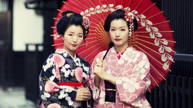 Two Japanese sisters dressed in the traditional kimonos.