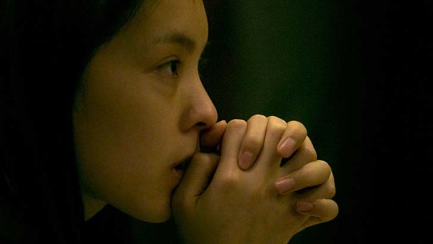 A woman sits outside a room waiting for relatives of the Chinese passengers onboard the missing Malaysia Airlines plane at a hotel in  Beijing.