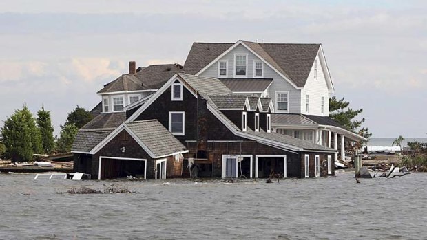 Disaster ... flooded houses in a storm-ravaged area of Barnegat Bay, New Jersey, on Friday.