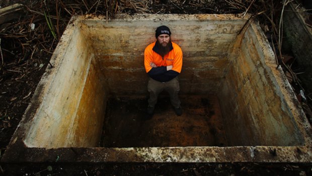 Nathan Amatnieks in a water tank that he wants to convert into a fire bunker.