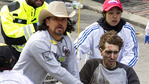 Carlos Arredondo helps Jeff Bauman, whose legs had to be amputated.