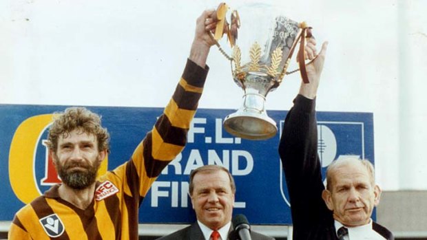 AFL games record holder, then Hawthorn captain Michael Tuck, holds the 1989 premiership cup aloft.
