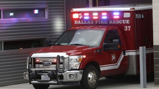 An ambulance pulls into the Dallas Fire-Rescue station 37 in Dallas. Three emergency workers from this location are under a 21-day quarantine after a patient they transported tested positive for Ebola. 