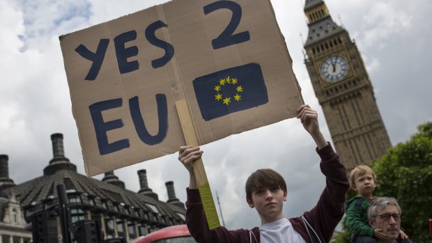 A small group of young people gather to protest on Parliament Square the day after a majority of the British public voted to leave the European Union.