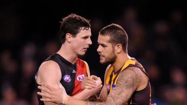 Essendon's Jake Carlisle shake with Hawthorn's Lance Franklin after the round 18 game between the teams in season 2013.  Franklin kicked eight goals in the Hawks' 143-87 win.