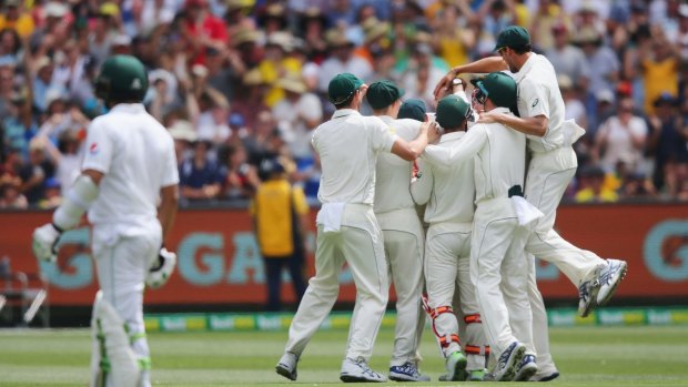 "Nice, Garry": Australian players celebrate after Steve Smith catches Sami Aslam of Pakistan off the bowling of Nathan Lyon.
