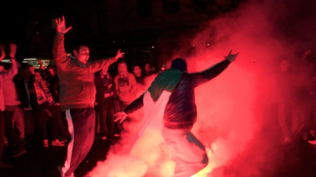 Italy fans set off flares on Lygon Street.