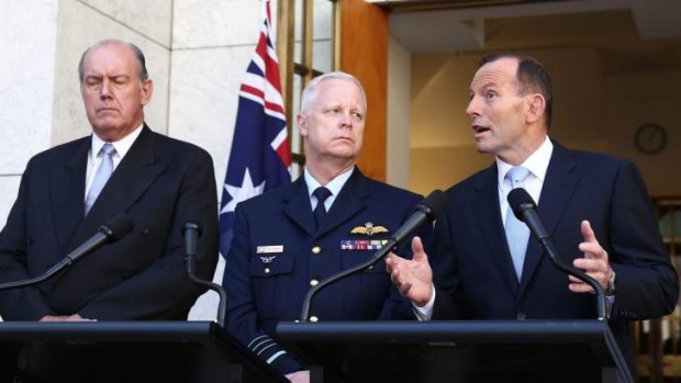 Prime Minister Tony Abbott announces Australia's involvement in air strikes, flanked by Defence Minister David Johnston and Chief of the Defence Force, Air Chief Marshal Mark Binksin.