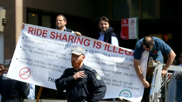 Taxi drivers protest against Uber at NSW State Parliament and threaten further action.