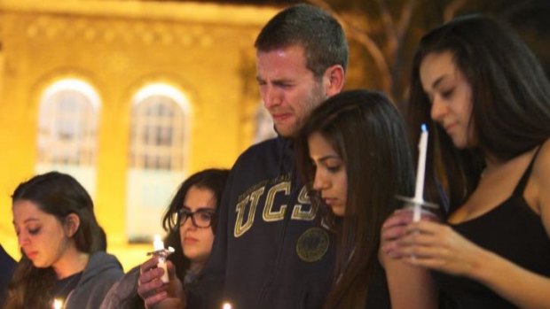 Students of University of California mourn at a candlelight vigil for the victims of the killing rampage.