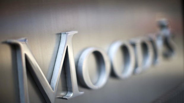 Moody's cited protracted weakness in financial markets for the downgrade.