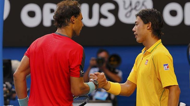 Ever the gentleman: Rafael Nadal wishes Kei Nishikori well after defeating the Japanese contender in straight sets.