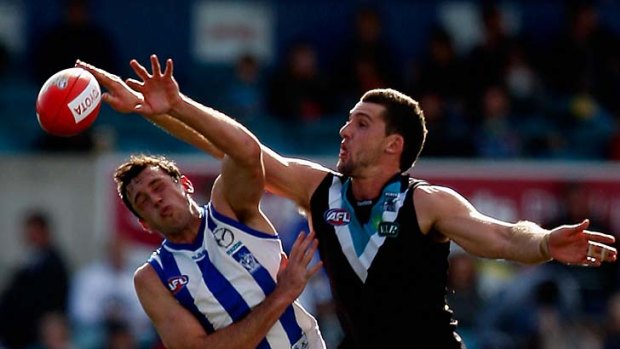 Flying fingers: Port ruckman Brent Renouf (right) outpoints Todd Goldstein in this contest.