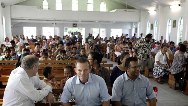 Tony Abbott's first public engagement was to attend Mass, at which he gave the second reading. With him are Scott Morrison, left, and President, Marcus Stephen.