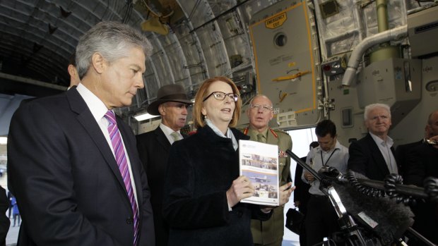 Parsimonious ... Julia Gillard, centre, announces the 2013 white paper with her defence minister, Stephen Smith, left) at Canberra's RAAF Fairbairn in 2013.