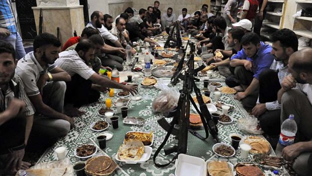 Guns ready &#8230; rebels in Aleppo break their Ramadan fast. The regime is bringing reinforcements to attack rebels, who claim to control 90 per cent of the city.