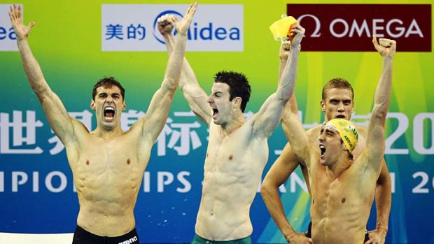 Australians Matthew Targett, James Magnussen and Matthew Abood celebrate their gold medal.