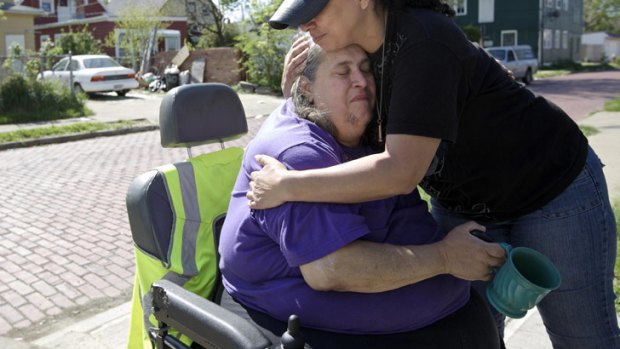 'Doesn't want to see us' ... Michelle Knight's grandmother, Deborah Knight, is comforted by a neighbour. Michelle is yet to be reunited with her family.