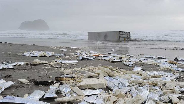 Debris from the Rena washes up, along with one of 88 containers.