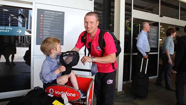 Brad Haddin with his son Zac after returning to Sydney on Tuesday.