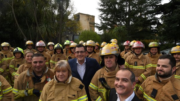 Voluntary and paid CFA members with Premier Daniel Andrews and Emergency Services Minister James Merlino in June.