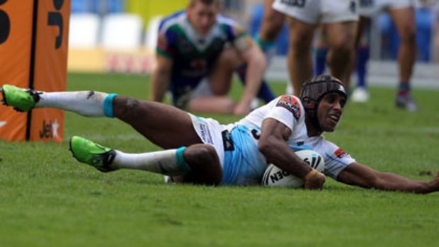 Game breaker...Gold Coast's Preston Campbell scores the game-winning try over the Warriors at Skilled Park yesterday. Campbell also recovered a short kick-off and stopped a certain try before getting knocked out in an accidental clash with Kevin Locke's knee.