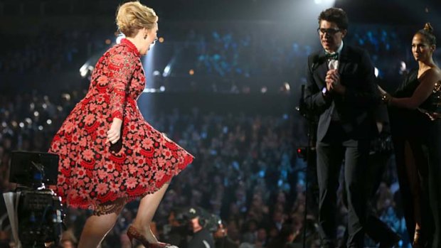Grammys gatecrasher attempts to intercept Adele's winning moment.