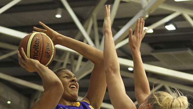 Tall talent: WNBA rookie Liz Cambage shoots over competition veteran Lauren Jackson in the WNBL.