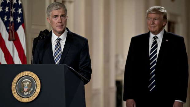 Neil Gorsuch left, speaks after being nominated to the US Supreme Court by Donald Trump.