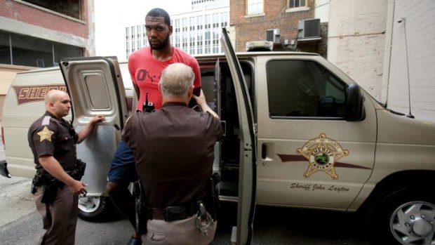 In trouble: Greg Oden is escorted into the Marion County Community Corrections building on Thursday in Indianapolis. Police arrested the former NBA No. 1 draft pick on battery charges.